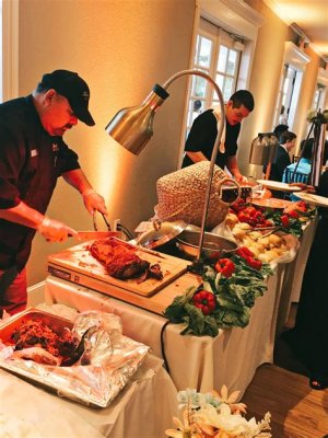Wedding guests creating their custom tacos at a taco bar with a variety of toppings including salsa, cheese, and seasoned meats.