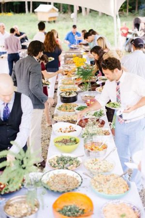 Wedding reception with a potluck-style spread of homemade dishes brought by guests, offering a diverse selection of flavors.